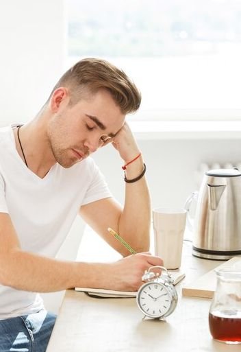 Worried man touching thinning hair due to stress